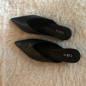 Woman’s black slide on dress shoe.
